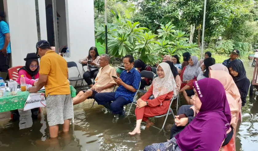 Warga TPS 14 Desa Bringkang kecamatan Menganti saat menunggu antrian pencoblosan setelah melakukan pendaftaran di tengah kondisi banjir, Rabu (14/2/2024). Foto: Dokumen suarasurabaya.net